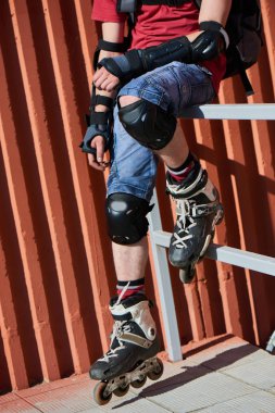 Tekerlekli paten merdiven korkuluk üzerinde oturan adam yakın çekim 