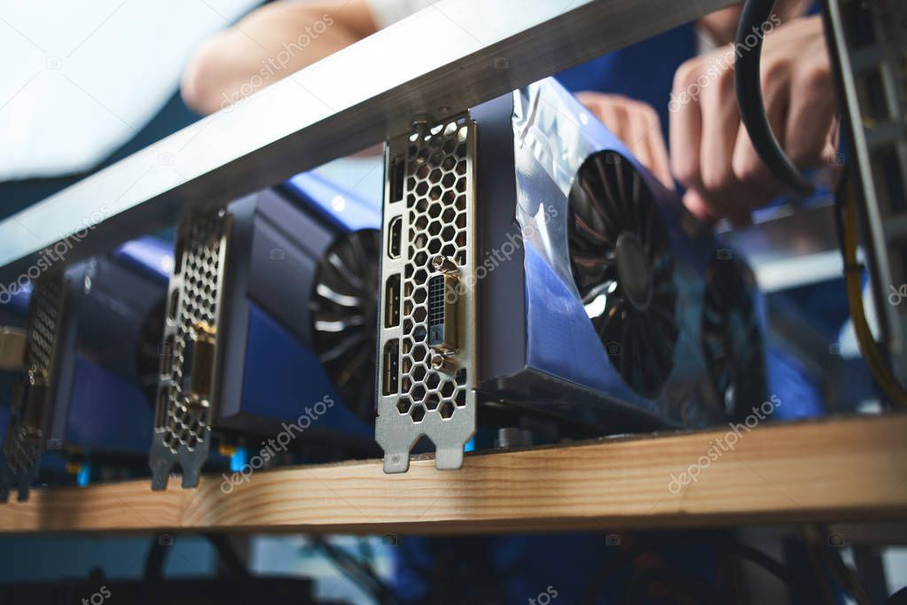 man collecting complement of video cards for cryptocurrency mining