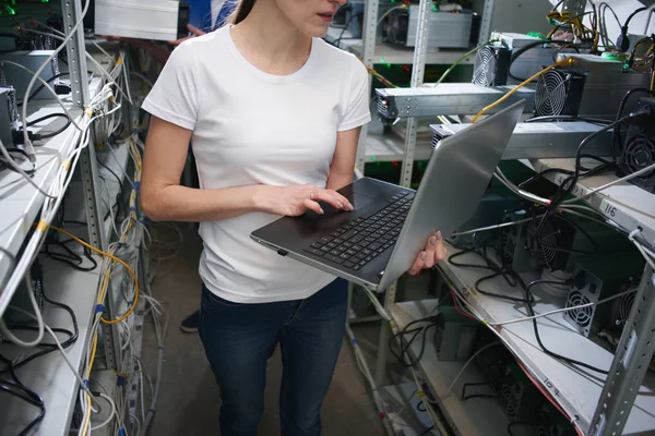 çiftliğinde çıkarım kripto para birimleri, Bitcoin incelemesi kavramı için dizüstü bilgisayarda çalışan kadın bilgisayar mühendisi