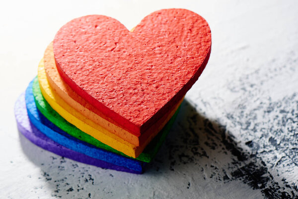 hearts painted in bright rainbow colors on grunge background, LGBT concept 