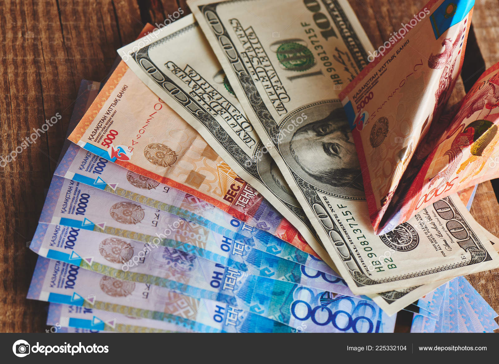 堆积如山的美元和哈萨克斯坦坚戈与钞票纸飞机上的木制背景特写商业和金融的概念——图库图片© amixstudio #225332104