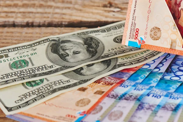 Haufen Amerikanischer Dollars Und Kasachstan Tenge Auf Hölzernem Hintergrund Nahaufnahme — Stockfoto