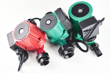 Red and green circulation pumps for heating on a white background. clipart