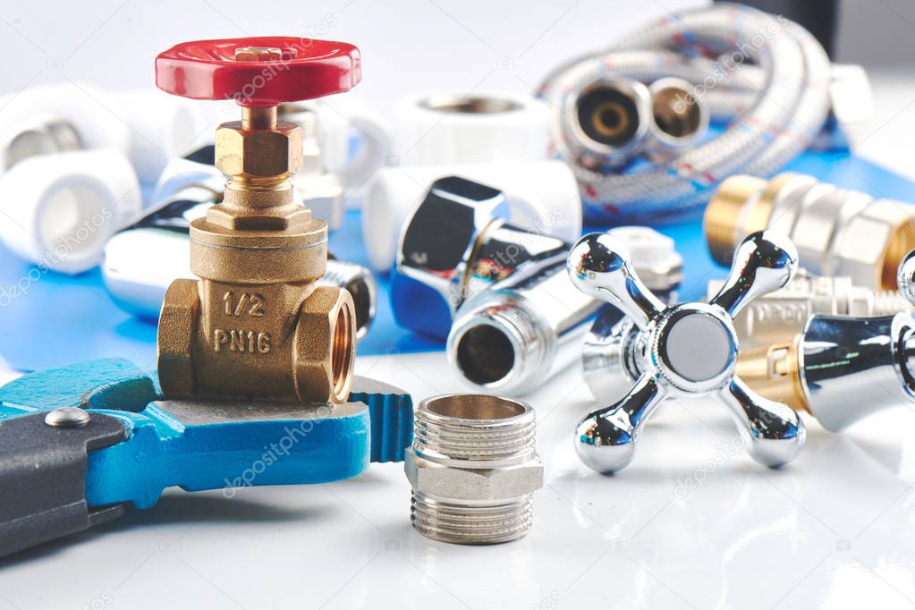 Plumbing parts, accessories and tools on a blue white background.