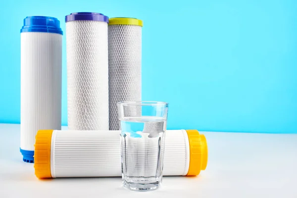 Water Filters Carbon Cartridges Glass White Blue Background Household Filtration — Stock Photo, Image