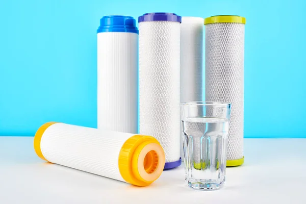 Waterfilters Carbon Cartridges Een Glas Een Witte Blauwe Achtergrond Filtersysteem — Stockfoto