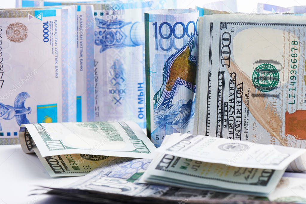 pile of American Dollars and Kazakhstani tenge money 
