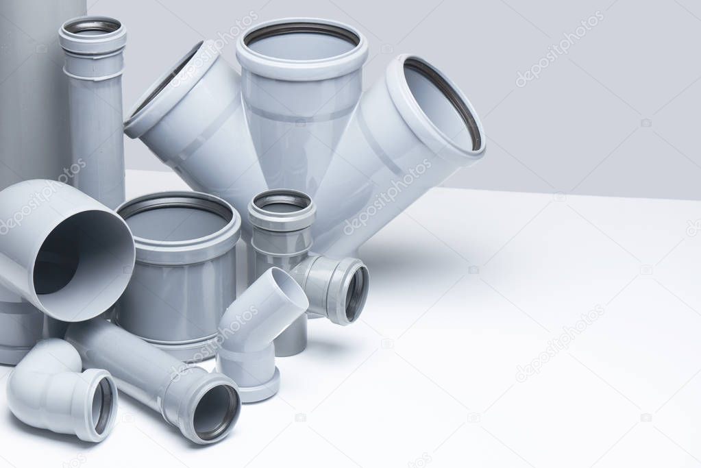 Plumbing, sewage. Gray polypropylene tubes on a white background in futuristic style