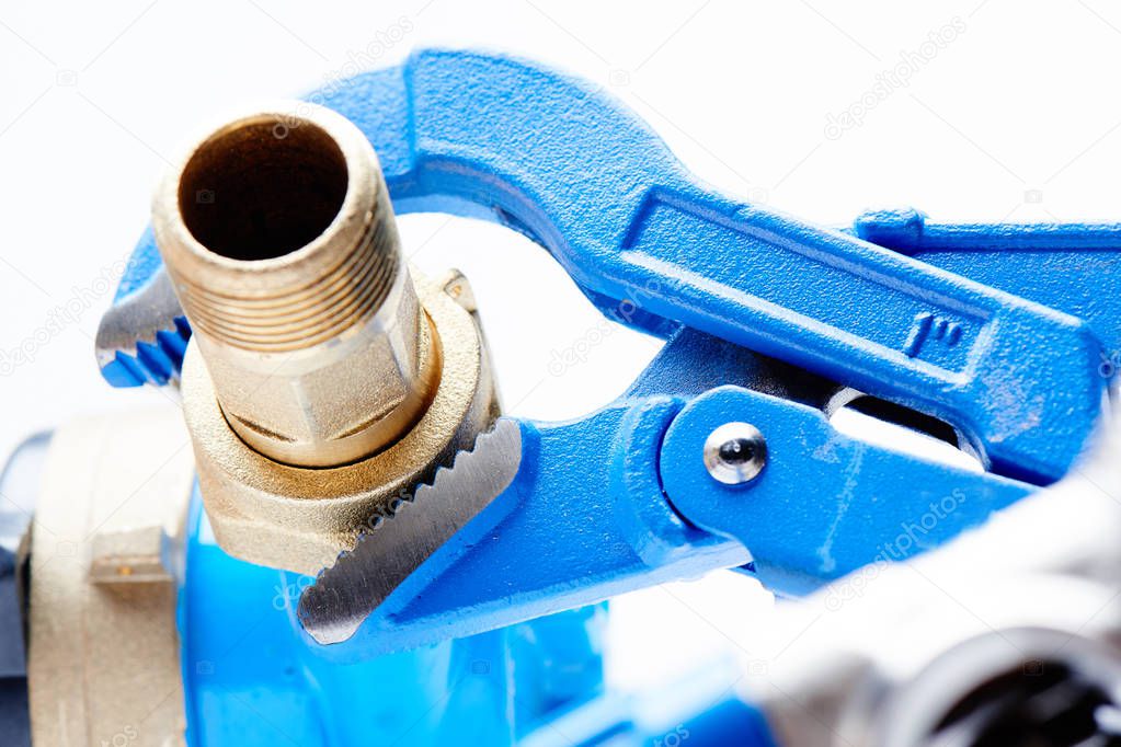 Plumbing concept, sanitary equipment. Blue pipe wrench on white background