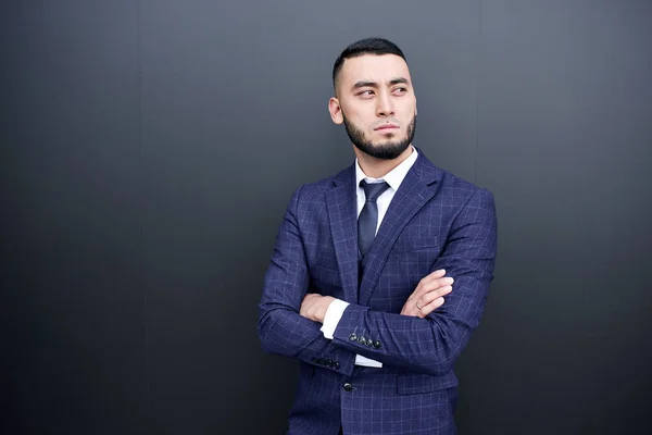 portrait of asian kazakh businessman in a suit on a black background