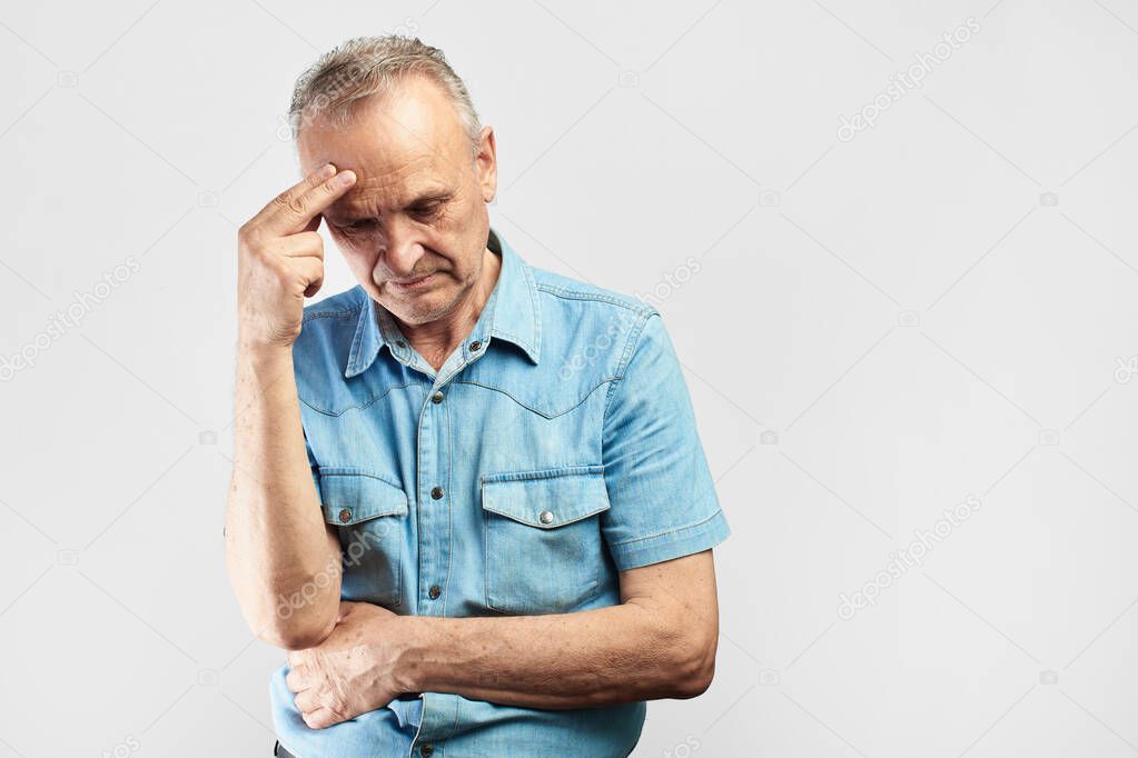 elderly gray-haired man with expression of pain on face put his hand on head, feels dizzy and cluster headache, migraine, high or low blood pressure isolated on white