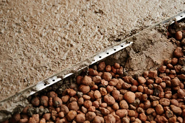 Bulk floor lightweight expanded clay construction in the apartment. Repair in the house concrete screed — Stock Image Bulk Floor Lightweight Expanded Clay Construction Apartment Repair House Concrete Stock Photo