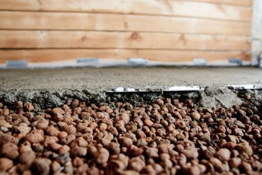 Bulk floor lightweight expanded clay construction in the apartment. Repair in the house concrete screed clipart