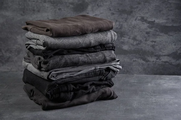 Stack Neatly Folded Dark Clothes Isolated Black Gray Background Close — Stock Photo, Image