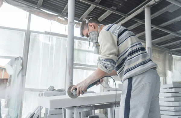 The master engraves the tombstone. Stone processing