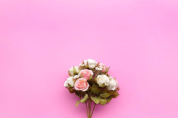 Top view of beautiful flower on pink background