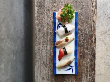 Seramik tabakta taze suşi ve Japon yemeği.