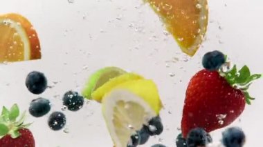 Karışık Meyve: Çilek, Yabanmersini, Limon, Limon ve Portakal Dilimleri bir akvaryuma düştü, 1080p 120fps.