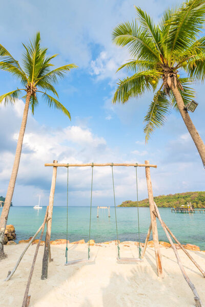 Wooden swing and coconut palm tree over summer beach sea in Ko Kut or Koh Kood, Trat Province,Thailand. Summer, Travel, Vacation and Holiday concept