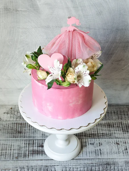 Pink cream cake for a baby girl with princess topper — Stock Photo, Image