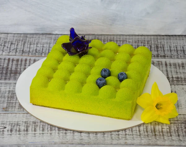 Square Chocolate velvet cake with daffodil and blueberries