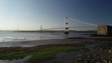 Drone hamle alçaktan ve yavaş nehir banka doğru Severn Köprüsü arasında bir güzel bahar akşamında