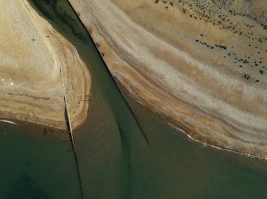 Nehir ağzı üzerinde uçar gibi dron kamera doğrudan aşağı Cuckmere cenneti kumsalda işaret
