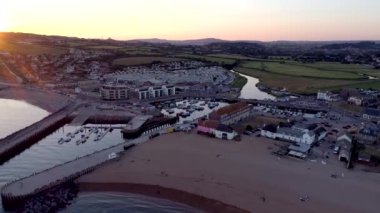 Bridport Dorset kırsal arka planda ile West Bay plaj üzerinde casus uçak iner. Gün batımında atış. 