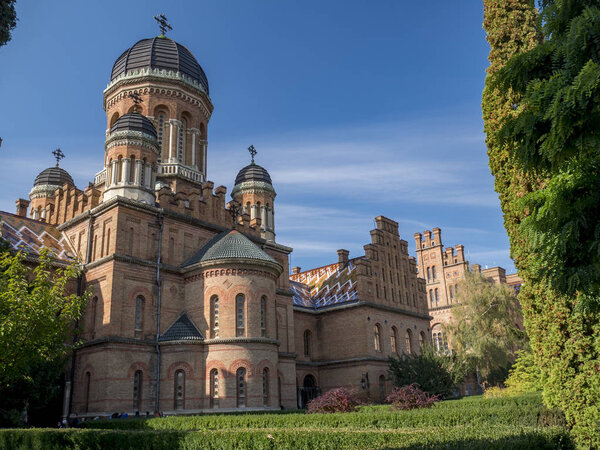 Domed tower of Chernivtsi National University in Chernivtsi Ukraine with autumnal trees