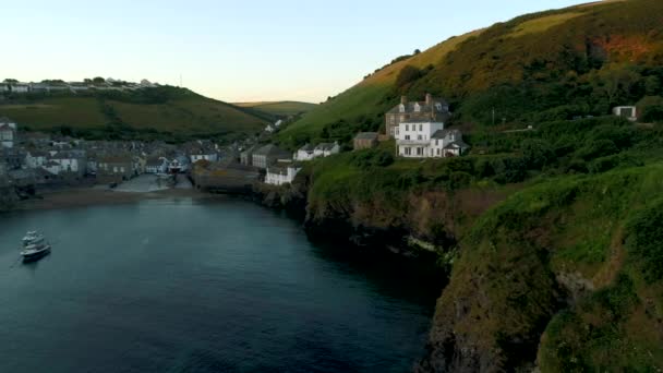 Drone flies sideways towards cliffs with the village Port Isaac in Cornwall behind. — Stock Footage Drone Flies Sideways Cliffs Village Port Isaac Cornwall Stock Video