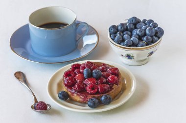 Kahve molası: fincan espresso, böğürtlen kabın içinde 