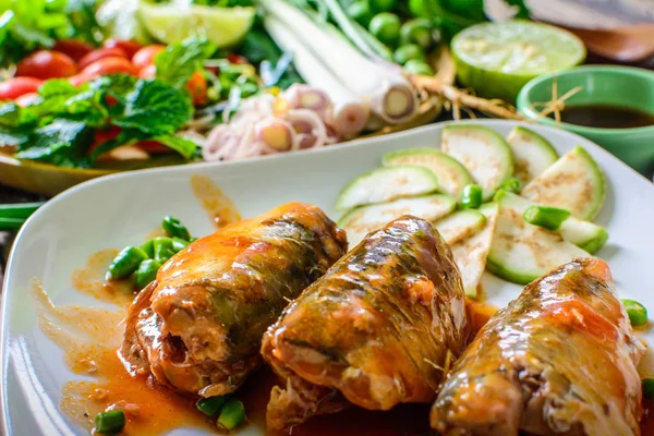Domates sos, sebze ve otlar masaya bir tabak içinde uskumru. Yum uskumru, Tayland mutfağı stili.