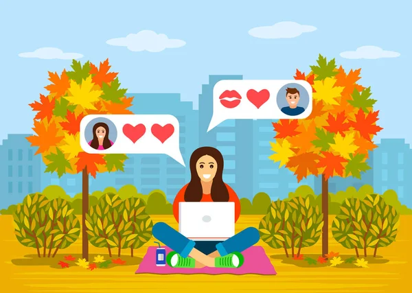 Krásná mladá dívka, která na podzim sedí v parku s notebookem v on-line korespondenci lásky. koncepce online datování a datování slepě. — Stockový vektor