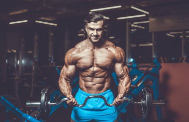 Yakışıklı genç uygun kas beyaz adam kilo kas, pozlar, pompalama spor modeli görünüm egzersiz eğitim su fitness ve vücut geliştirme spor beslenme kavramı içecekler