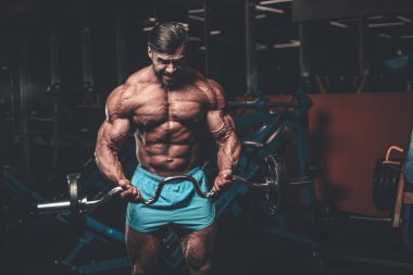 Yakışıklı genç uygun kas beyaz adam kilo kas, pozlar, pompalama spor modeli görünüm egzersiz eğitim su fitness ve vücut geliştirme spor beslenme kavramı içecekler