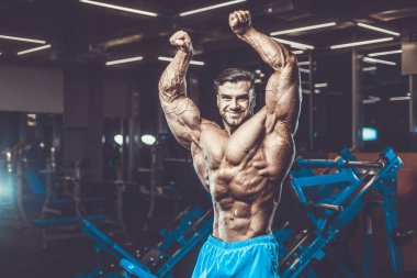 Yakışıklı genç uygun kas beyaz adam kilo kas, pozlar, pompalama spor modeli görünüm egzersiz eğitim su fitness ve vücut geliştirme spor beslenme kavramı içecekler