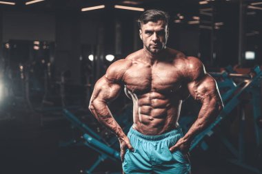 Yakışıklı genç uygun kas beyaz adam kilo kas, pozlar, pompalama spor modeli görünüm egzersiz eğitim su fitness ve vücut geliştirme spor beslenme kavramı içecekler
