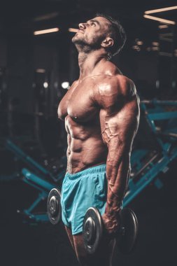 Yakışıklı genç uygun kas beyaz adam kilo kas, pozlar, pompalama spor modeli görünüm egzersiz eğitim su fitness ve vücut geliştirme spor beslenme kavramı içecekler