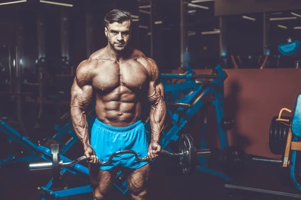 Yakışıklı genç uygun kas beyaz adam kilo kas, pozlar, pompalama spor modeli görünüm egzersiz eğitim su fitness ve vücut geliştirme spor beslenme kavramı içecekler