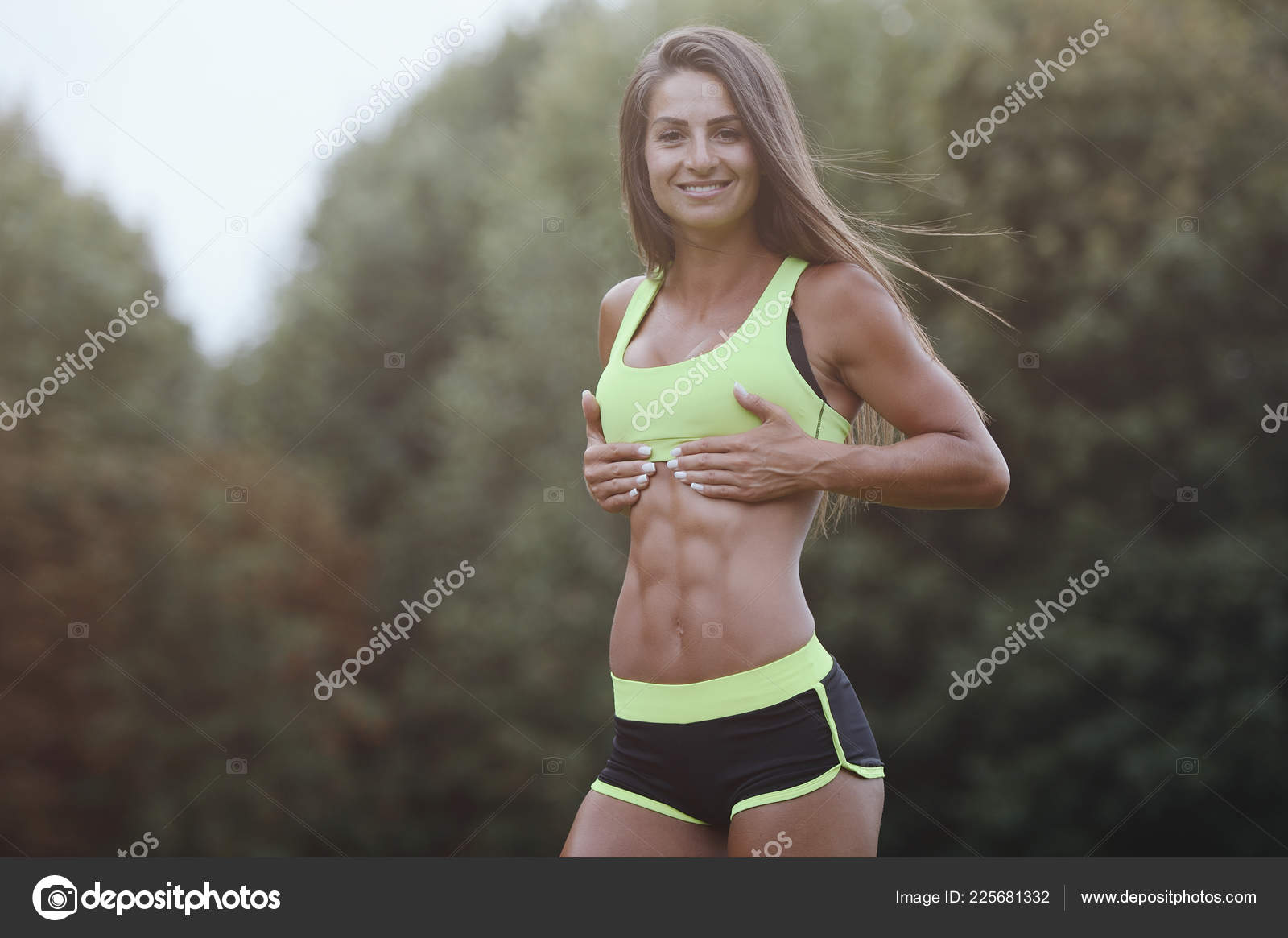 Beautiful abs. Young caucasian woman with athletic body shape is