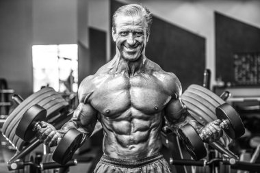 Acımasız güçlü vücut geliştirmeci atletik kasları egzersiz vücut geliştirme kavramı arka plan - kas vücut geliştirmeci yakışıklı erkekler spor salonu çıplak gövde kavramı spor ve diyet egzersiz yapıyor pompalama adam yaşlı