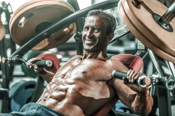 Acımasız güçlü vücut geliştirmeci atletik kasları egzersiz vücut geliştirme kavramı arka plan - kas vücut geliştirmeci yakışıklı erkekler spor salonu çıplak gövde kavramı spor ve diyet egzersiz yapıyor pompalama adam yaşlı