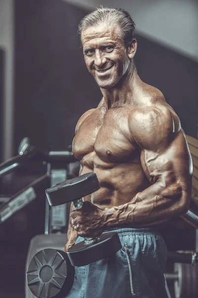 Acımasız güçlü vücut geliştirmeci atletik kasları egzersiz vücut geliştirme kavramı arka plan - kas vücut geliştirmeci yakışıklı erkekler spor salonu çıplak gövde kavramı spor ve diyet egzersiz yapıyor pompalama adam yaşlı