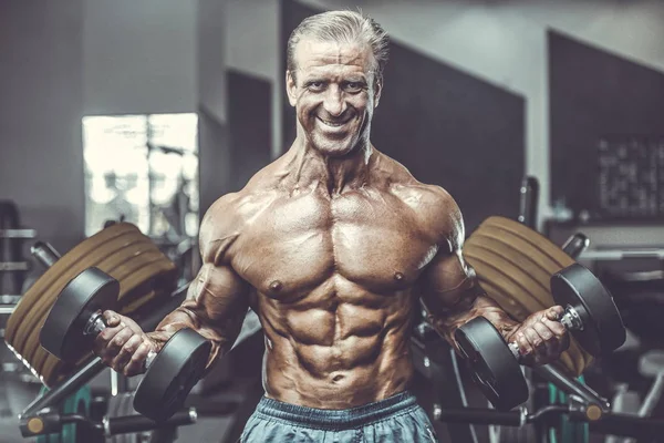 Acımasız güçlü vücut geliştirmeci atletik kasları egzersiz vücut geliştirme kavramı arka plan - kas vücut geliştirmeci yakışıklı erkekler spor salonu çıplak gövde kavramı spor ve diyet egzersiz yapıyor pompalama adam yaşlı