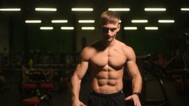 Yakışıklı atletik erkekler kaslarını şişiriyor, spor yapıyor, vücut geliştirme egzersizleri yapıyor, vücut geliştirme konsepti uyguluyor, kaslı vücut geliştiriciler spor salonunda çıplak vücut egzersizleri yapıyor.