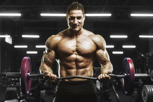 Handsome strong athletic men pumping up muscles workout barbell curl bodybuilding concept background - muscular bodybuilder men doing exercises in gym naked torso