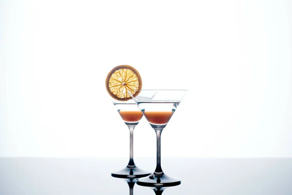 Martini glass on a white background with an orange slic — Stock Photo, Image