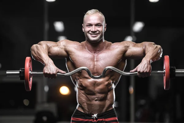 Handsome strong bodybuilder athletic men pumping up muscles with — Stock Photo, Image