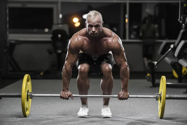 Handsome strong bodybuilder athletic men pumping up muscles with — Stock Photo, Image