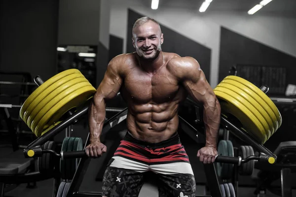 Stilig stark bodybuilder atletiska män pumpa upp muskler med — Stockfoto